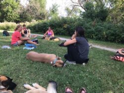 PrairieBurn K9 Academy ultimate shadow experience participants listening to Debbie in a middle of a park