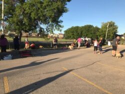 PrairieBurn K9 Academy ultimate shadow experience participants working with their dogs in an empty parking lot