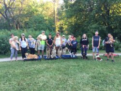 PrairieBurn K9 Academy ultimate shadow experience participants taking a group photo with their dogs